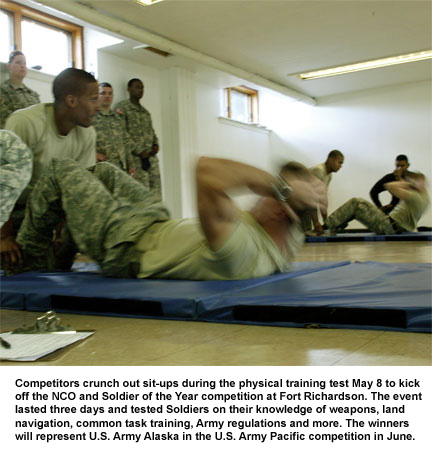 Competitors crunch out sit-ups during the physical training test May 8 to kick off the NCO and